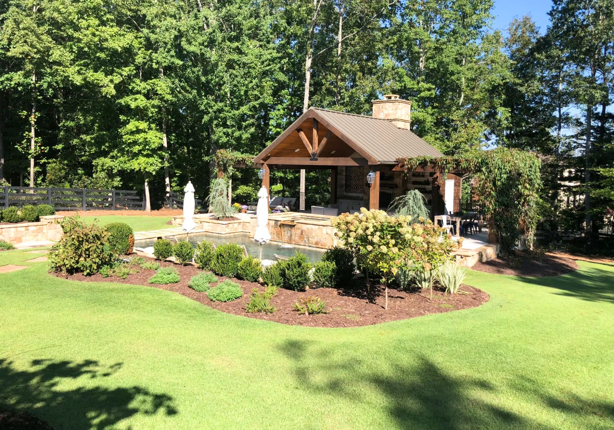 Backyard Pavilion With Lush Garden And Fountain