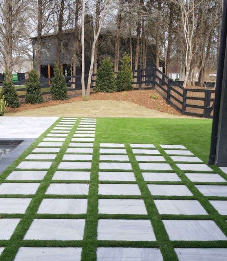 Modern Backyard With Grass And Paver Pathway