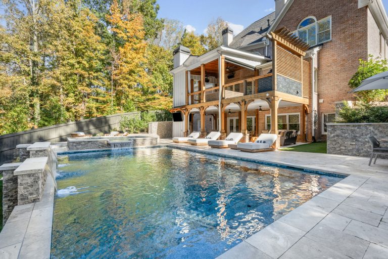 Elegant modern swimming pool with raised spa, clean architectural lines, and beautifully designed landscape.